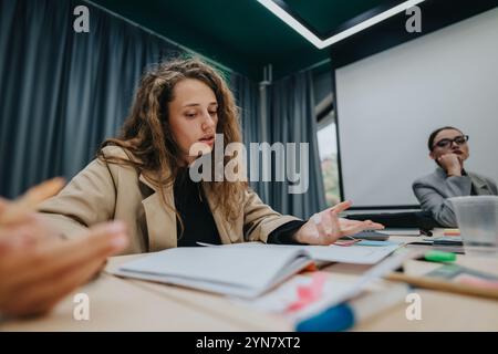 Focused students engaged in a classroom discussion setting Stock Photo