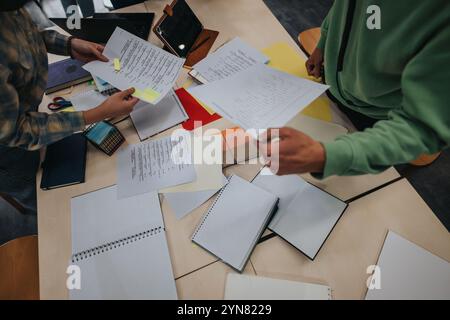 Students collaborating on assignments in a classroom setting Stock Photo