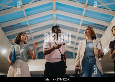 International business professionals walking through urban city atrium Stock Photo