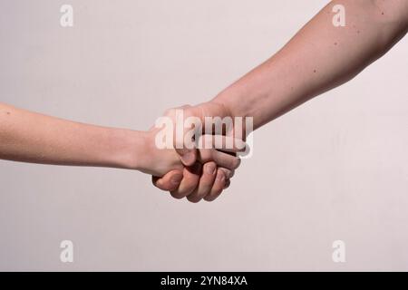 Holding hands. Handshake. Helping hand. Rescue gesture. Support hand. Concept of support. Strong hold. Two hands, helping hand of a friend. Handshake Stock Photo