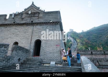 Beijing, China - Oct 23rd, 2024: Climbing up the Juyongguan Pass Great Wall of China during sunset. Stock Photo