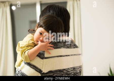 Girl being carried by father Stock Photo