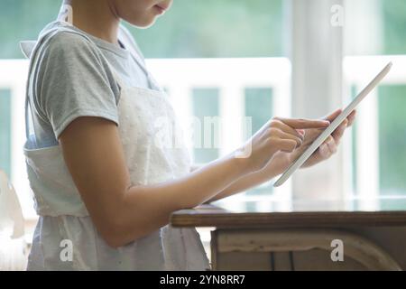 Girls using tablets in the classroom Stock Photo