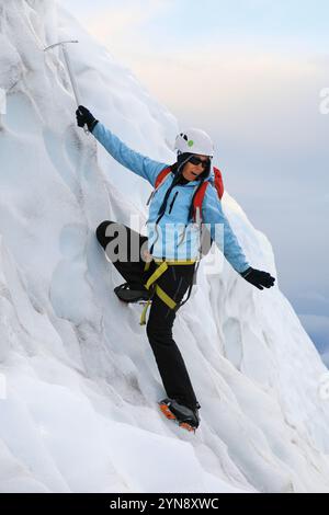 Female mountain climber using ice pick Stock Photo - Alamy