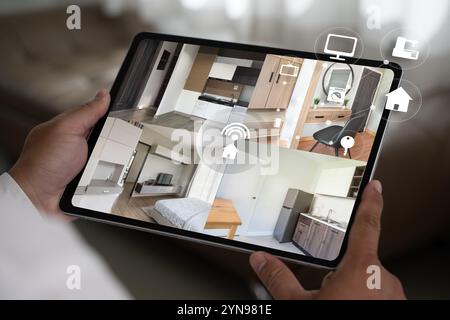 cctv security system man monitoring at office from smart phone Camera Footage On Screen Stock Photo