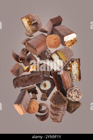 Different chocolate products in air on grey background Stock Photo