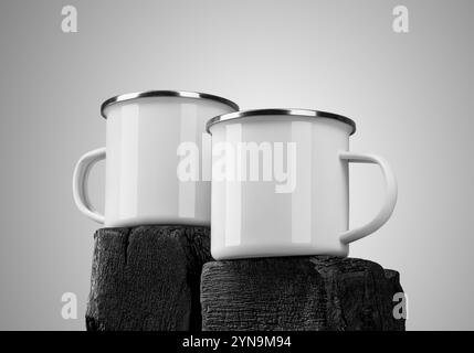 Тemplate of two white enamel mugs with a silver border, in the center of a wooden burnt board, isolated on the background. Мockup iron mug on timber, Stock Photo