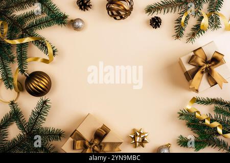 Christmas background with fir branches, golden ribbons, ornaments and wrapped gifts in festive flat lay design. Top view, copy space. Stock Photo