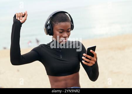 woman dancing while listening music in headphones Stock Photo
