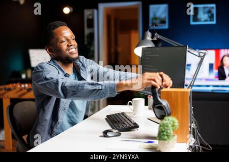 Systems manager developing computer commands for servers and coding in programming language. Technical expert typing binary code in HTML terminal window, improves database cybersecurity. Stock Photo