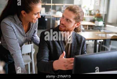 Mixed team of software engineers brainstorming ideas. Diverse app developers collaborating as group Stock Photo