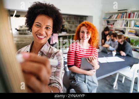 Young businesswoman leading a discussion during a meeting with her colleagues. Stock Photo