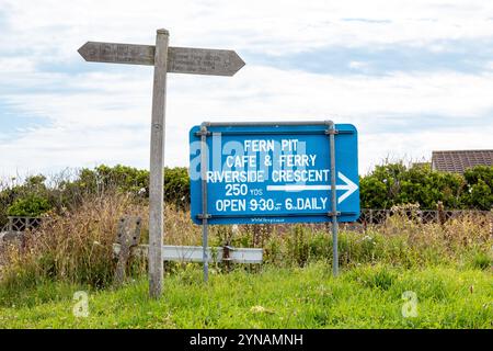 The wooden signpost on the South West Coast Path near the Fern Pit Cafe. Pentire Headland, Newquay, Cornwall, England, UK Stock Photo
