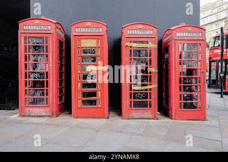 Decommissioned red public telephone boxes, The Strand, London, UK Stock Photo