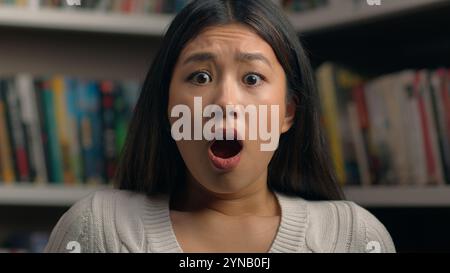 Close-up surprised young asian woman in shock with frightened expression opens mouth shocked by bad news feeling stress female student teacher Stock Photo
