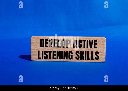 Develop active listening skills message written on wooden blocks with ...