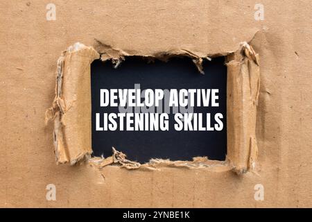 Develop active listening skills message written on black paper with red ...