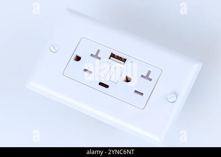Electrical outlet features multiple sockets USB charging ports, providing convenient Self Test GFI access for powering devices in stylish minimalistic design Stock Photo