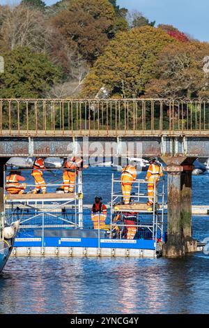 Network Rail engineers repairing and maintaining the railway line or track over a bridge over the Lymington River in Hampshire, UK Stock Photo