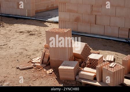Construction site with stacked clay bricks Stock Photo