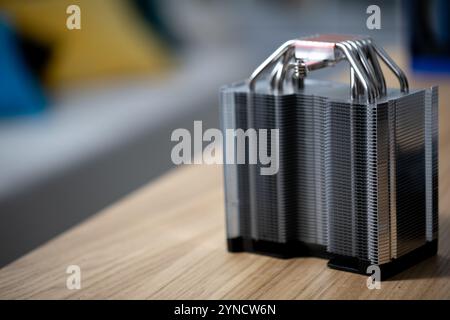 A Detailed and CloseUp Image Depicting a Computer Heat Sink Located on a Wooden Surface Stock Photo