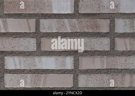 Beige and Grey brick wall background close up. Gray stone tile block background with horizontal texture of gray brick. Gray brick surface Stock Photo