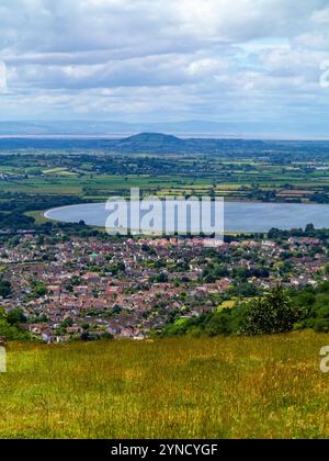 View of the town of Cheddar from Cheddar Gorge a tourist attraction in the Mendip Hills in Somerset south west England UK with reservoir in distance. Stock Photo