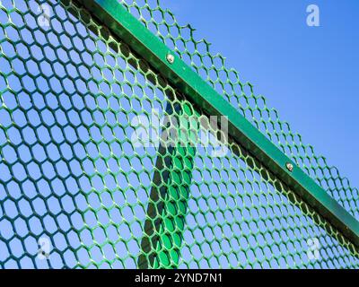 Fragment of a fence made of plastic mesh Stock Photo