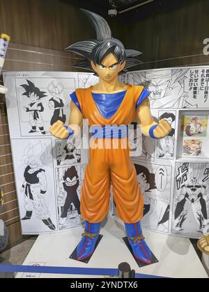 Kita Ward, Osaka, Japan. Dec 24, 2023. A human size model Goku from Dragon Ball comic cartoon character figure at a Jump Shop at HEP FIVE mall Stock Photo