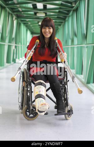 Dark-haired woman with plaster leg sitting in wheelchair, 35 years old, hospital, Hospital Vienna, Austria, Europe Stock Photo