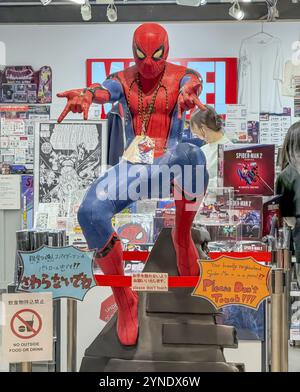 Kita Ward, Osaka, Japan. Dec 24, 2023. A human size model Spider Man from a comic cartoon character figure at HEP FIVE mall Stock Photo