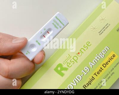 Calgary, Alberta, Canada. Dec 30, 2021. A person holding a Rapid Response Covid-19 Antigen Rapid test device box Stock Photo