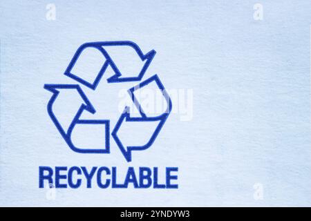 Recyclable symbol on a white cardboard Stock Photo