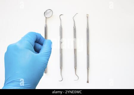 A dentist about to starts examining a patient. Professional Dental Hygiene cleaning tools. Calculus and Plaque Remover Set, Dental Scaler And Mouth Mi Stock Photo
