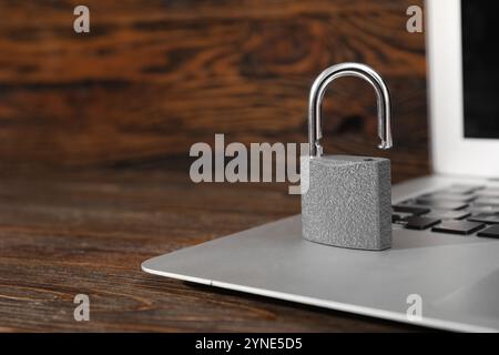 Padlock with laptop on wooden background Stock Photo