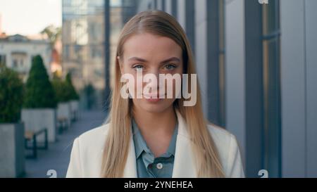 Close-up smiling confident caucasian woman businesswoman girl student lady entrepreneur professional manager consultant lawyer posing outdoors near Stock Photo