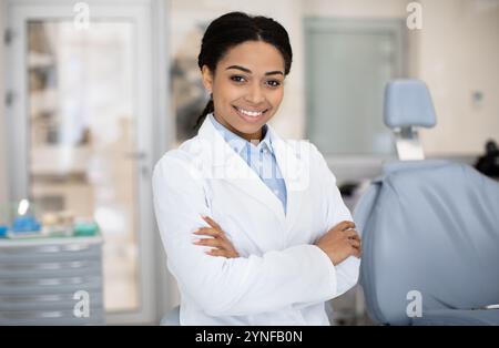 Female Dentist. Portrait Of Happy Black Stomatologist Woman Standing With Folded Arms Stock Photo