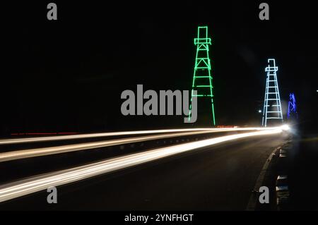 the atmosphere of the night on Tarakan City with old oil tower decorated with neon lights Stock Photo