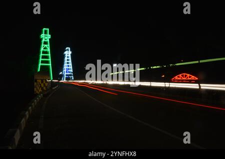 the atmosphere of the night on Tarakan City with old oil tower decorated with neon lights Stock Photo