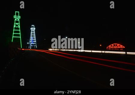 the atmosphere of the night on Tarakan City with old oil tower decorated with neon lights Stock Photo