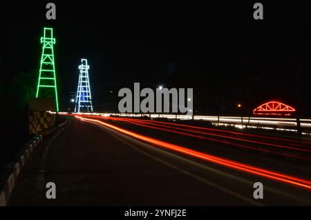 the atmosphere of the night on Tarakan City with old oil tower decorated with neon lights Stock Photo