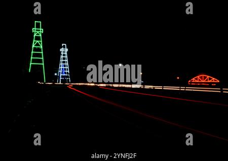 the atmosphere of the night on Tarakan City with old oil tower decorated with neon lights Stock Photo