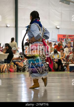 Native American female jingle dancer wearing a rainbow-colored satin skirt dancing at the Last Chance Pow Wow in Helena, Montana. Stock Photo