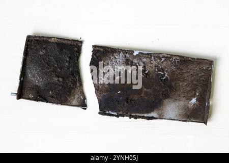 Dirty, oily, broken parts of an old kitchen exhaust fan. Stock Photo