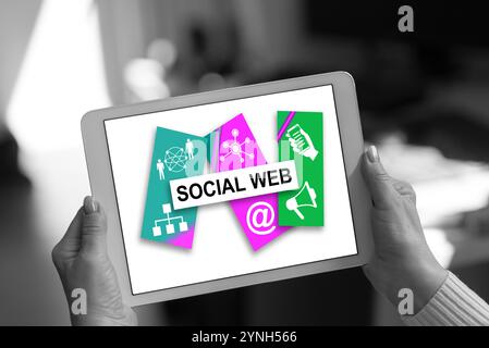 Social web concept shown on a tablet held by a woman Stock Photo
