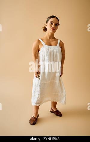 A young woman with short stature poses confidently in an elegant dress, showcasing beauty. Stock Photo