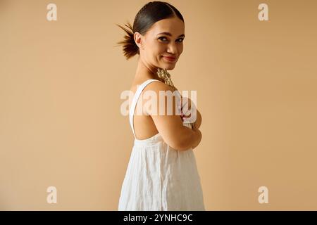 Young woman with short stature poses confidently in an elegant dress, embracing diversity. Stock Photo