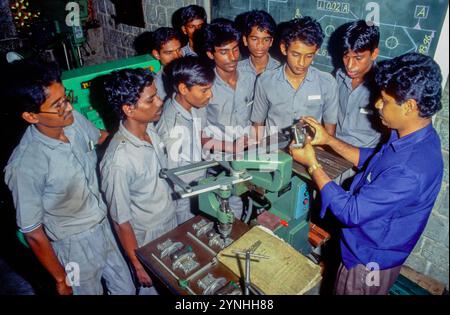 India, Solinghur, students listen to a teacher in a factory school. Stock Photo