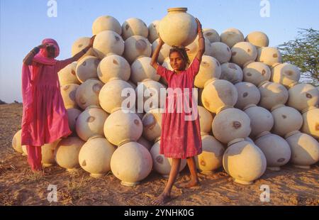 India, Rajastan, woman is selling the water jars her husband has made. Stock Photo