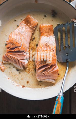 Salmon fried on oil on pan Stock Photo
